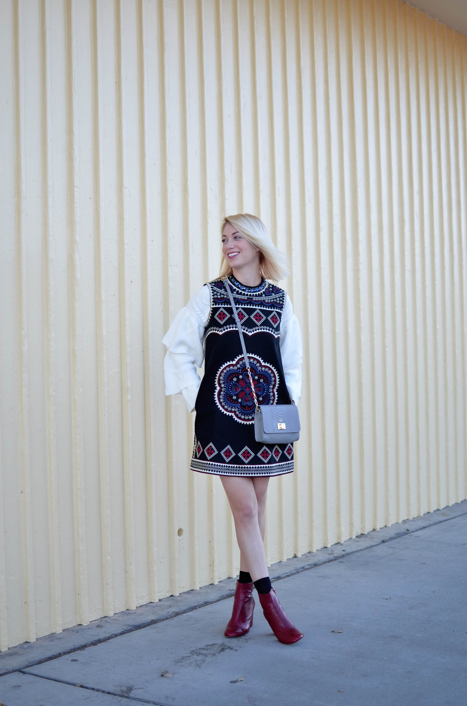 embellished shift dress, very tiered cable knit sweater, red boots, gigi new york grey cross body bag