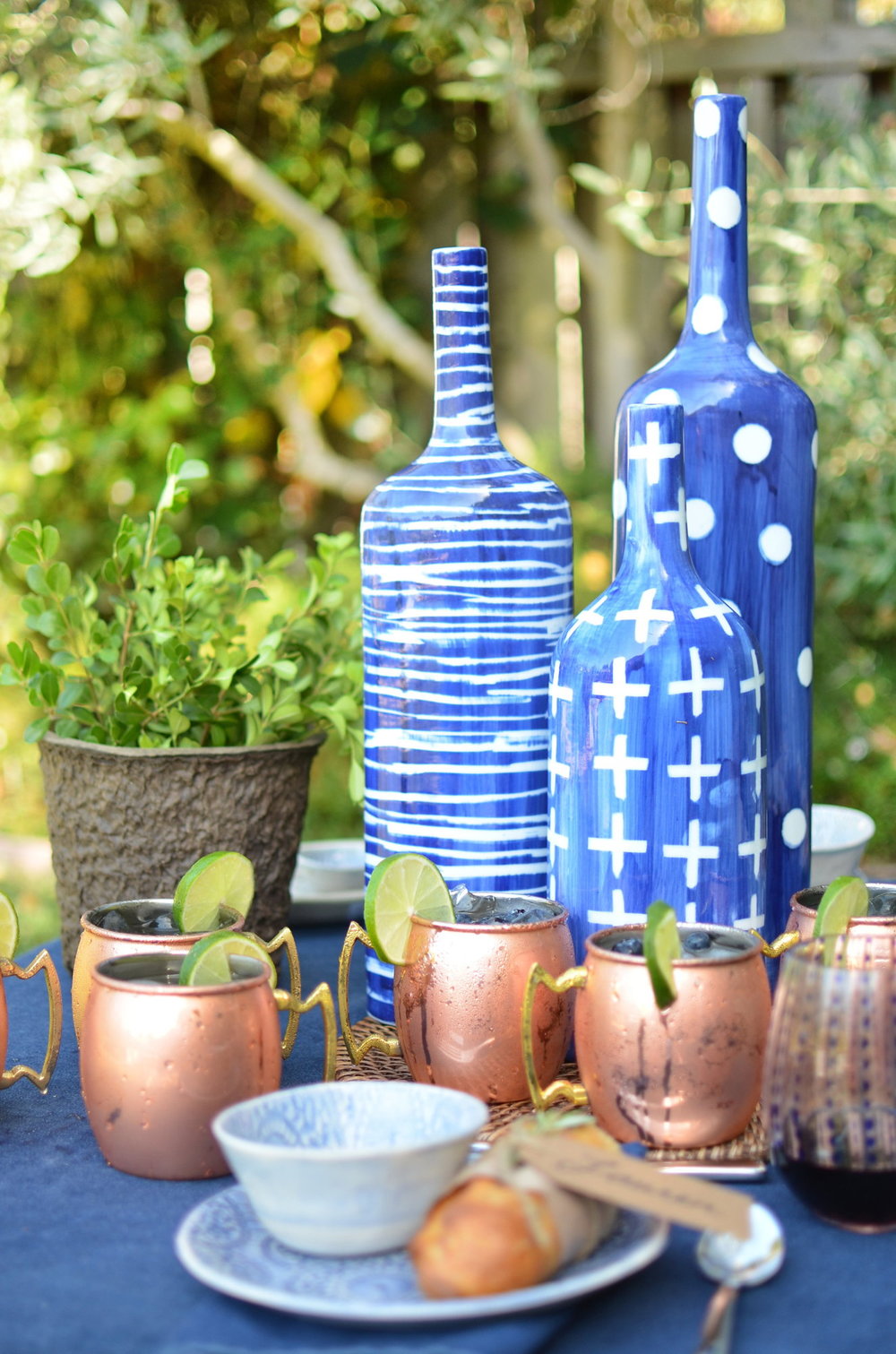 blue denim table cloth, blue porcelain mugs, copper moscow mule mugs
