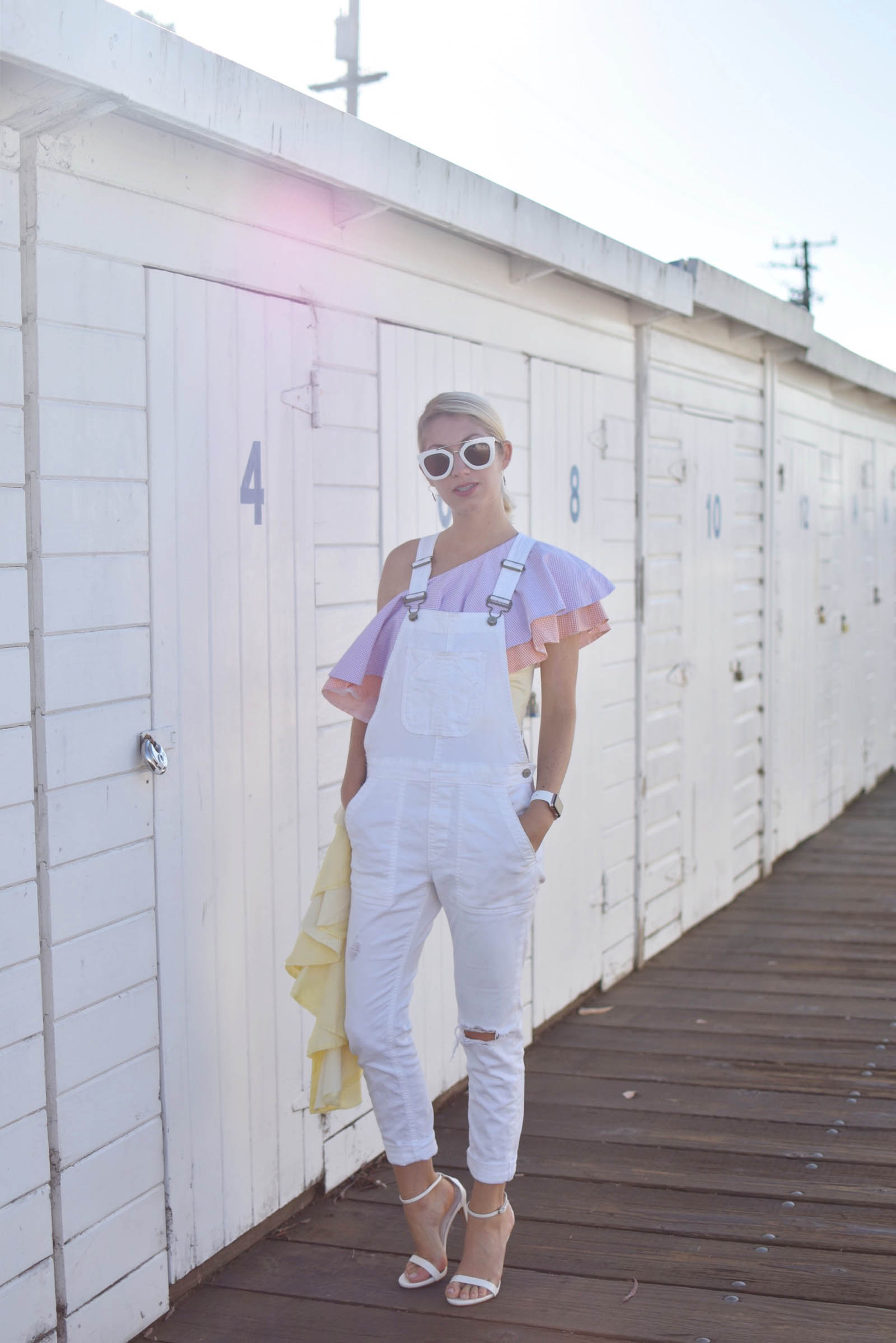 white overalls, styled with pastel ruffle top