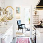 white kitchen, colorful rug, brass hardware