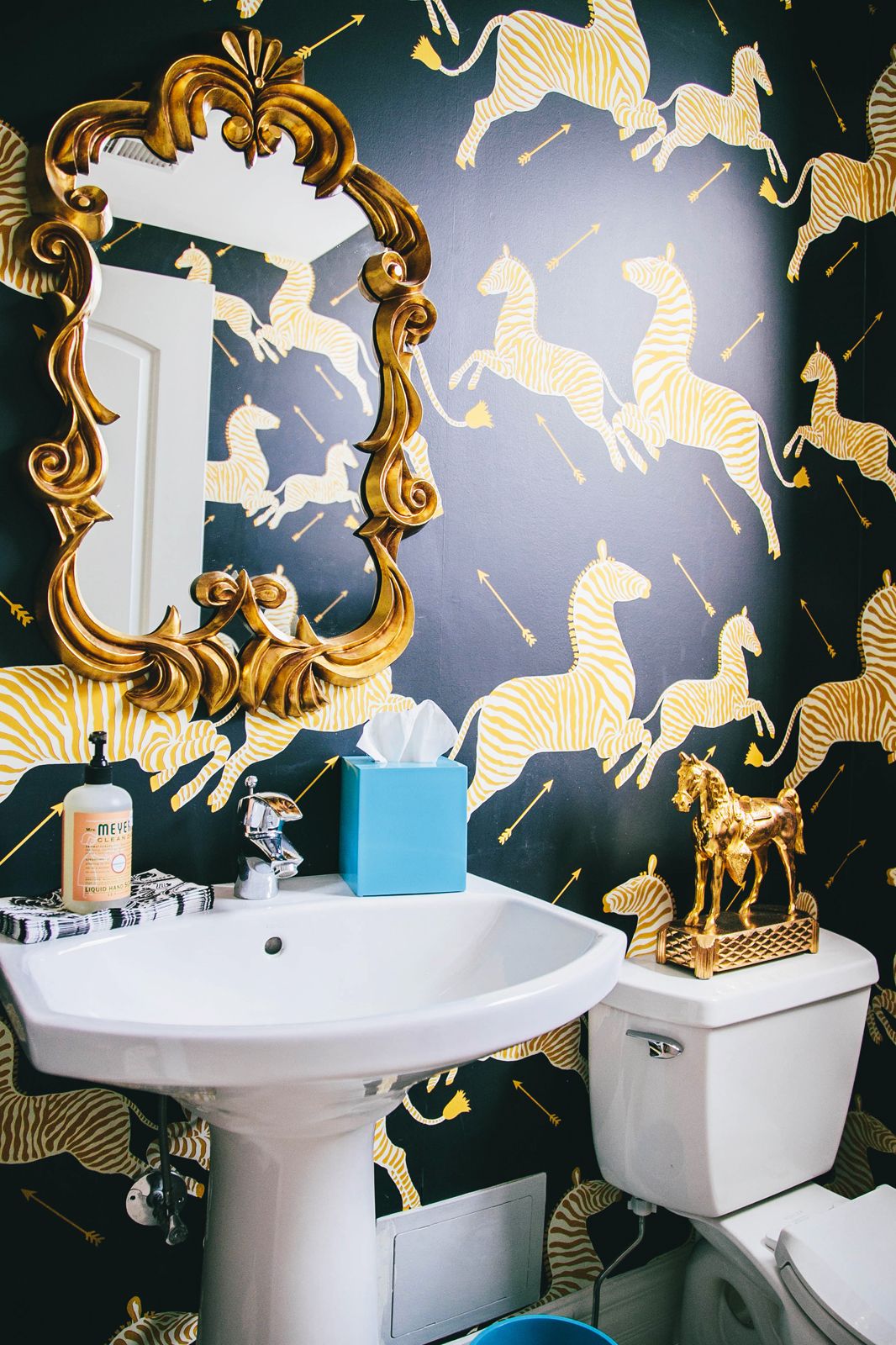 scalmandre zebra wallpaper and gold bathroom
