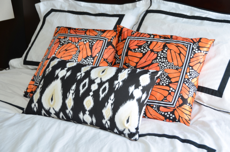 mopboard black bedroom walls, bedroom renovation, orange butterfly pillows // thestylesafari.com