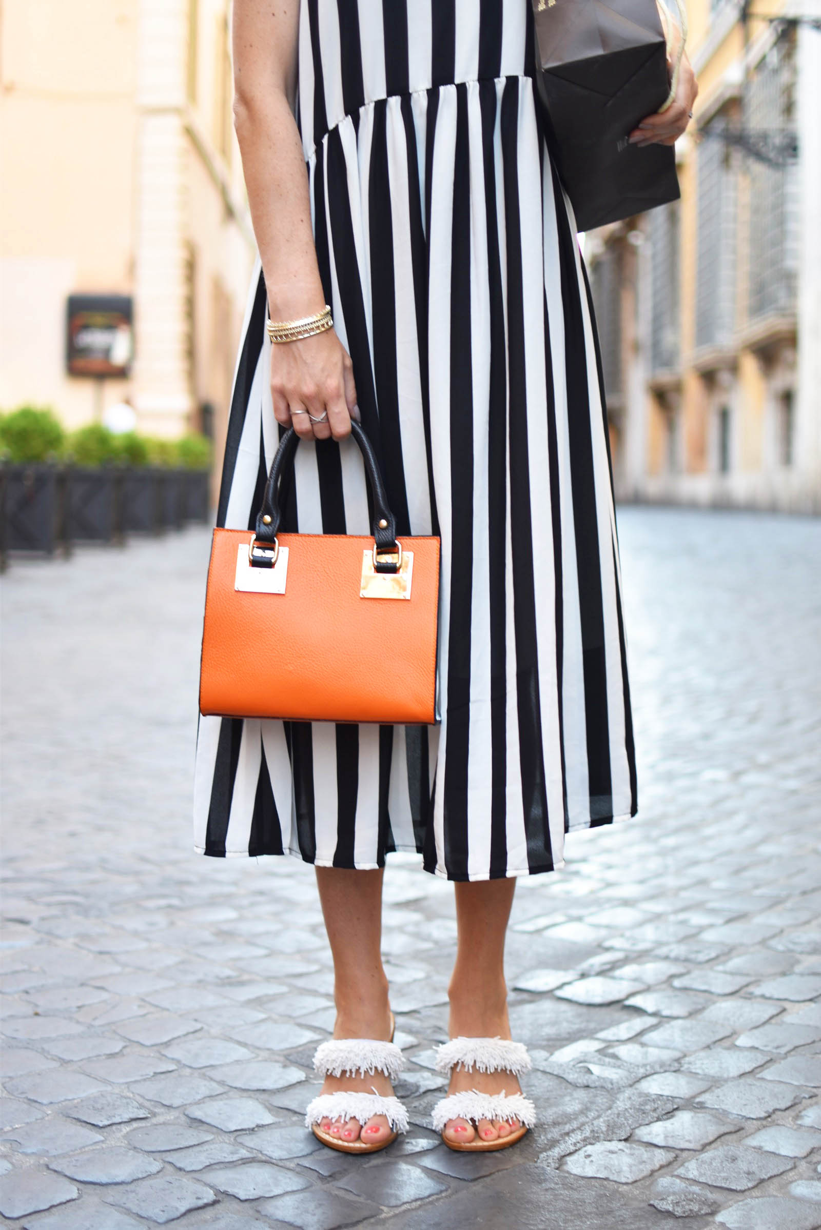 black and white striped dress and orange italian leather bag in Rome