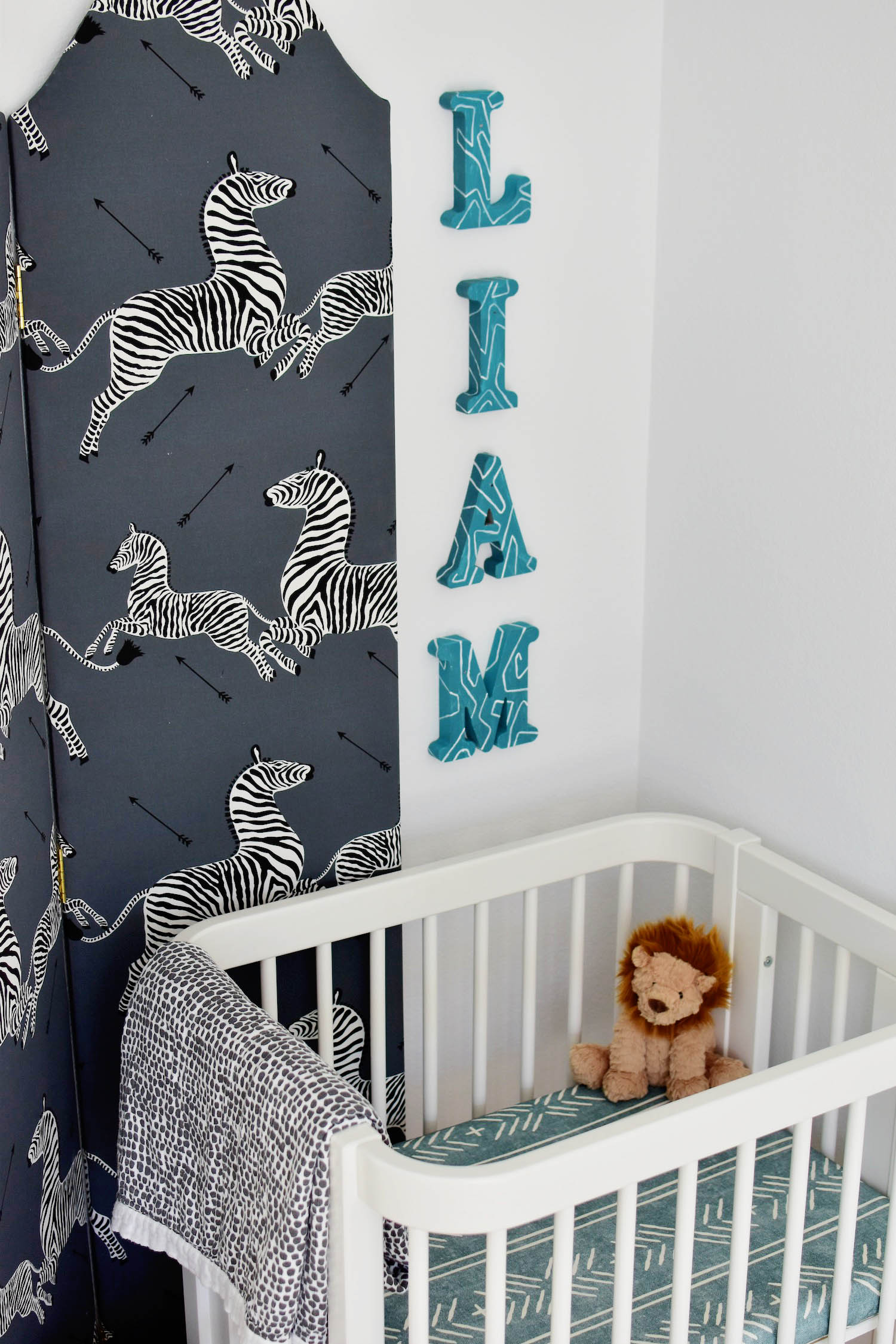 Liam's nursery nook, covertible Nestig wave crib, TheInside scalamandre upholstered screen, hand painted letter name sign