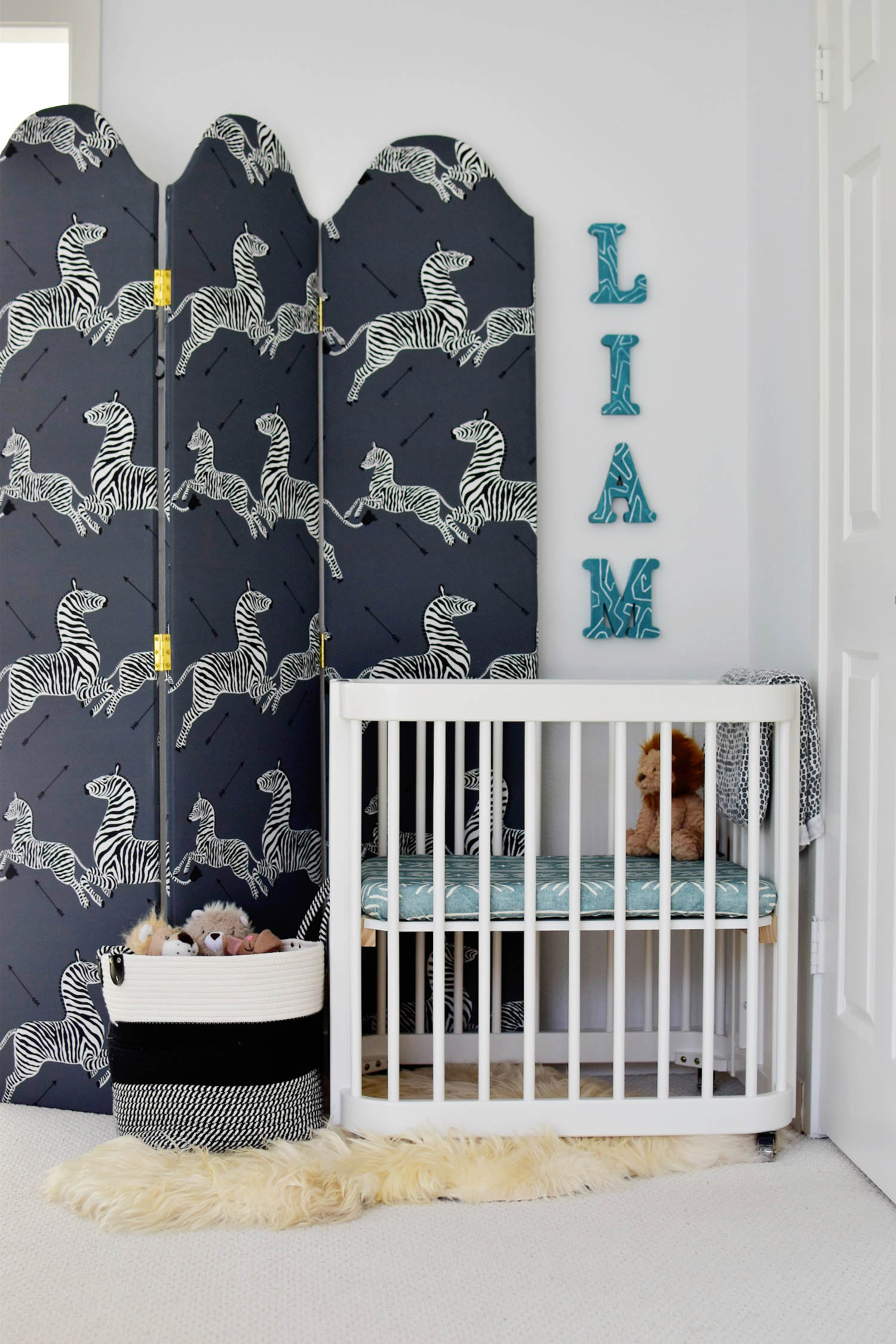 Liam's master bedroom nursery nook, covertible Nestig wave crib, TheInside scalamandre upholstered screen, hand painted letter sign